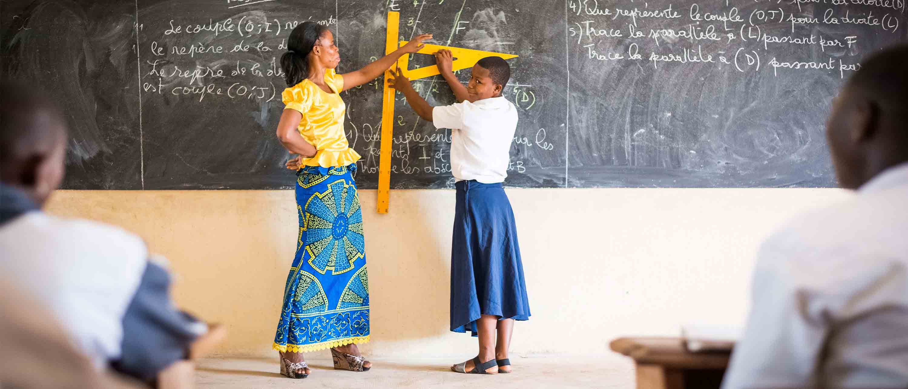 teacher and pupil by blackboard